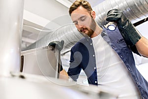 Man working at craft brewery or beer plant