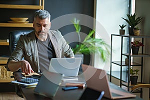 Man Working at Desk With Laptop Computer
