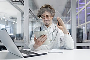 Man Working at Desk With Laptop and Tablet