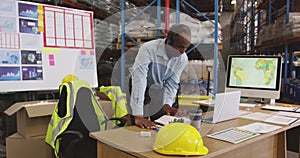 Man working at a desk in a warehouse 4k