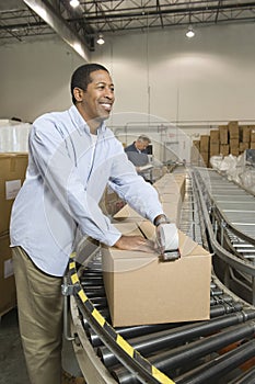 Man Working In Distribution Warehouse