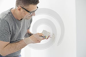 Man working on electrical outlet