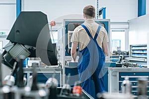 Man working in factory on semi automatized production line