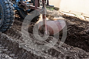 A man working in the field. A man plows the land with motor cultivator