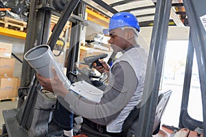 Man working with forklift in warehouse