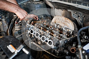 Man working in garage, workshop, auto servicing center.