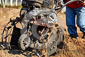 Man working in the garden with Garden Tiller