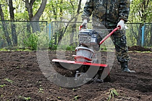 Man working in the garden preparing ground cultivator