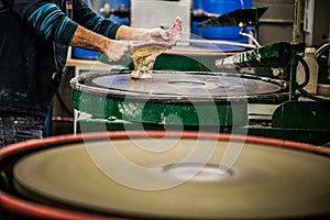 Man Working a Glass Blown Vase on Silica Sanding Disk