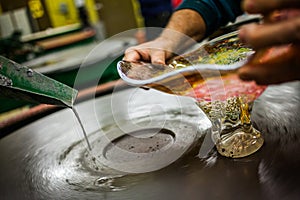 Man Working a Glass Blown Vase on Spinning Silica Sanding Disk