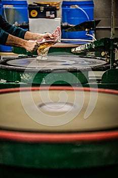 Man Working a Glass Blown Vase on Silica Sanding Disk photo