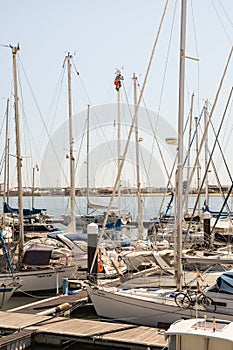 Man working on a high yacht mast.