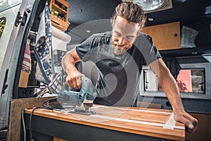 Man working on his camper van