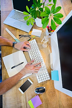 Man working at his desk and typing on keyboard