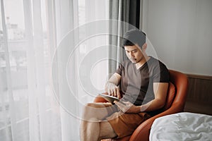 Man working with his digital tablet in the hotel in concept of workation.