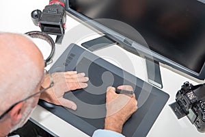 Man working on his graphics tablet, close up of hands