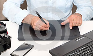 Man working on his graphics tablet, close up of hands