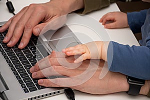 Man working from home with the baby on his laps