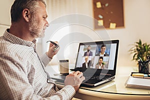 Man working from home having online group videoconference