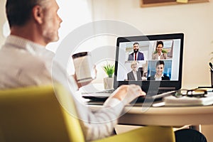 Man working from home having online group videoconference photo