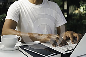 A man working at home and using laptop on the table. Technology and business concept