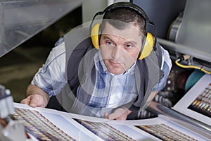 man working with industrial printer