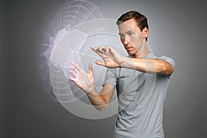 Man working with interactive Sci-Fi HUD interface.