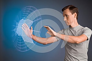 Man working with interactive Sci-Fi HUD interface.