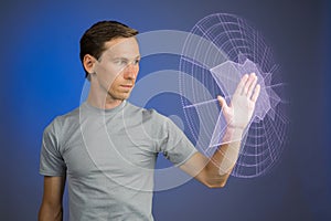 Man working with interactive Sci-Fi HUD interface.