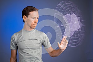 Man working with interactive Sci-Fi HUD interface.