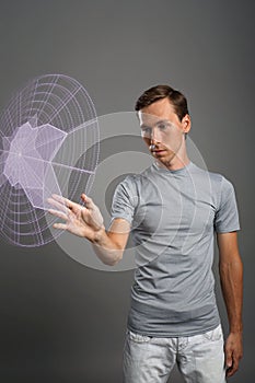 Man working with interactive Sci-Fi HUD interface.