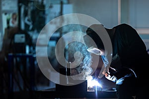 Man working on iron with grinder