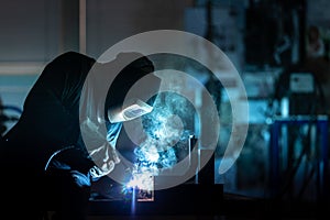 Man working on iron with grinder