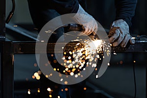 Man working on iron with grinder
