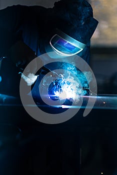 Man working on iron with grinder