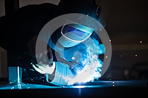 Man working on iron with grinder