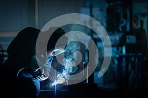 Man working on iron with grinder