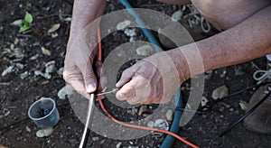 Man working on irrigation emitters