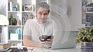 Man working with laptop computer at home at morning