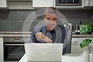 Man working with laptop computer at home office