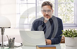Man working with laptop computer in home office
