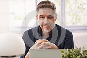 Man working with laptop computer in home office