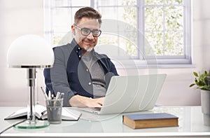 Man working with laptop computer in home office