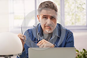 Man working with laptop computer in home office