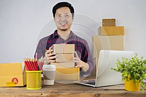 The man working laptop computer from home on wooden floor with postal parcel