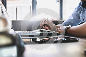 Man Working At laptop Computer and notebookIn Contemporary Office