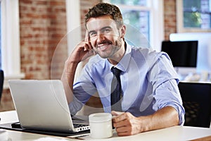 Man Working At Laptop In Contemporary Office