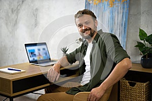 Man Working on Laptop at Desk