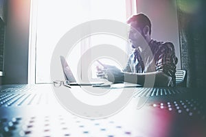 Man working with laptop and digital tablet