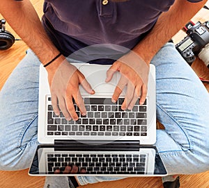 Man working with a laptop on the floor. Work from home